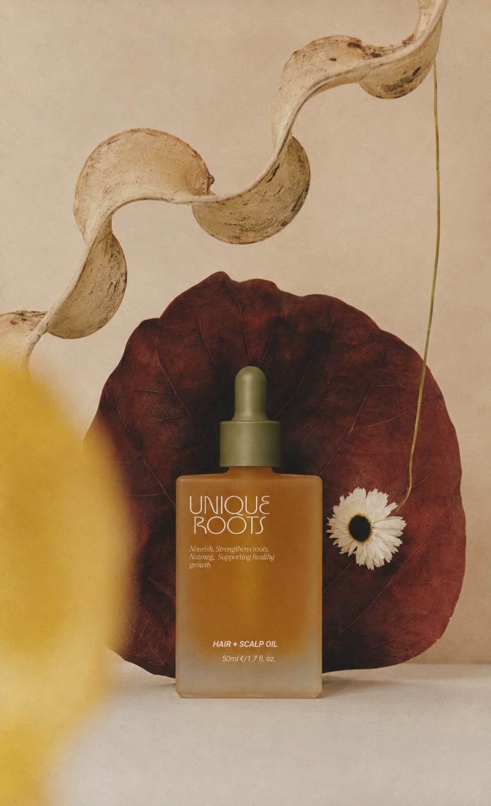 Product photograph of the amber Unique Roots bottle